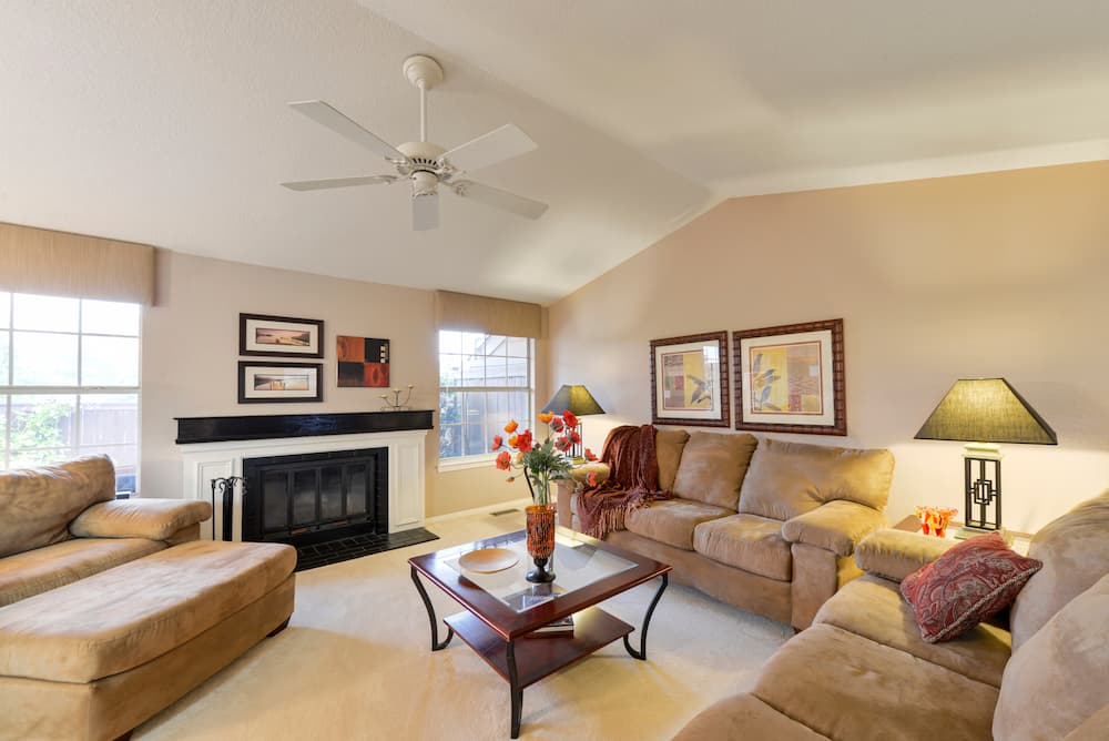 A beautiful well lit living room staged for home tours by CalHome sits ready to accept potential buyers